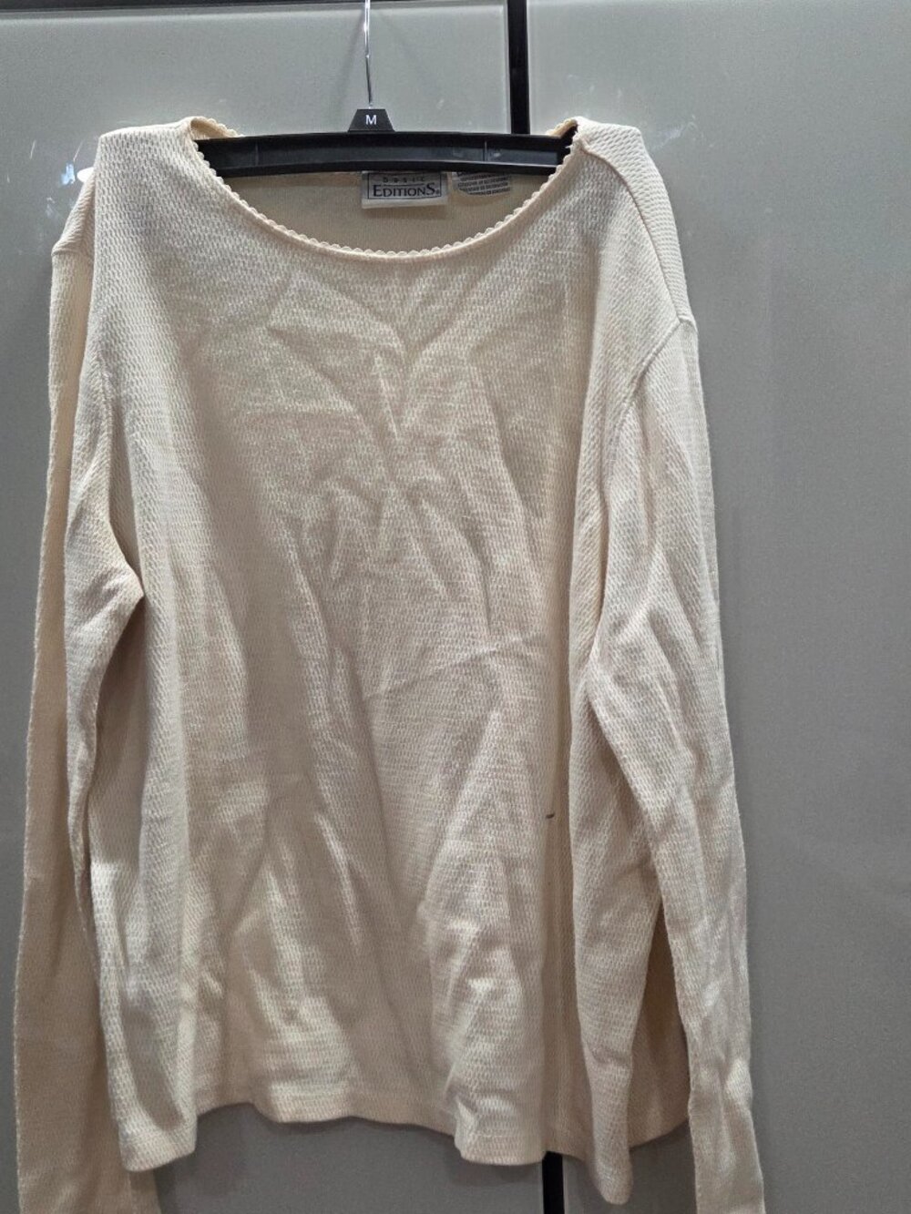Cream-colored, waffle-knit long-sleeve relaxed fit sweater